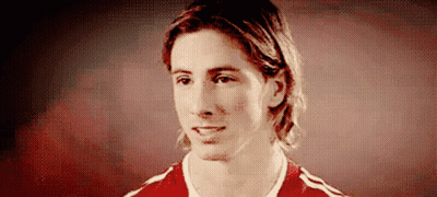 A Man With Long Hair Is Wearing A Red And White Shirt GIF