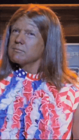 A Man With Long Hair Is Wearing A Red White And Blue Dress GIF