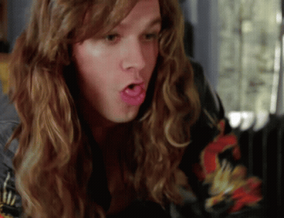 A Man With Long Hair Making A Funny Face With His Mouth Open GIF