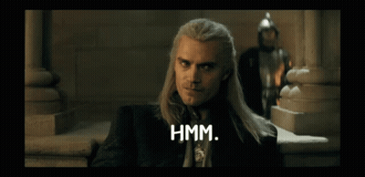A Man With Long Hair Says Hmm In Front Of A Man In A Knight 'S Helmet GIF
