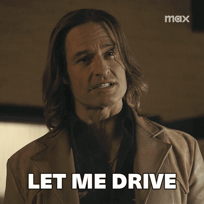 A Man With Long Hair Says Let Me Drive In Front Of A Max Logo GIF