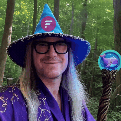 A Man With Long Hair Wearing A Blue Wizard Hat And Glasses GIF