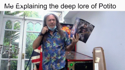 A Man With Long Hair Wearing A Face Mask Is Explaining The Deep Lore Of Potito In A Living Room GIF
