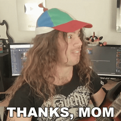 A Man With Long Hair Wearing A Hat And A Shirt That Says " Thanks Mom " GIF