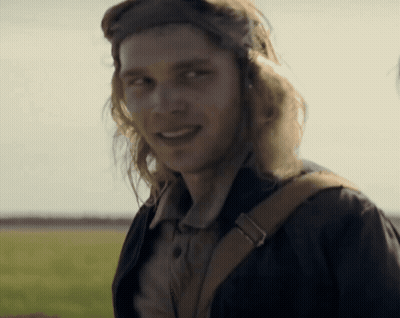 A Man With Long Hair Wearing A Helmet And Goggles Smiles GIF