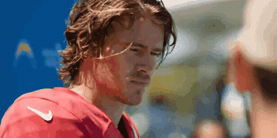 A Man With Long Hair Wearing A Red Nike Jersey GIF