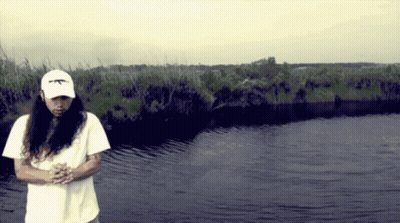 A Man With Long Hair Wearing A White Hat That Says Ak47 GIF