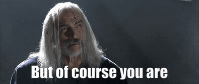 A Man With Long White Hair And A Beard Says " But Of Course You Are " GIF