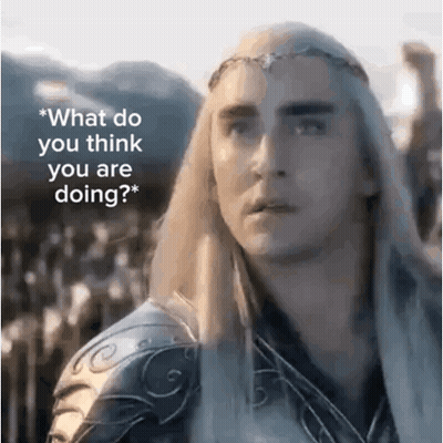A Man With Long White Hair And A Crown On His Head Is Standing In Front Of A Mountain . GIF