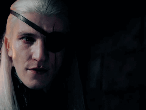 A Man With Long White Hair And An Eye Patch On His Eye GIF