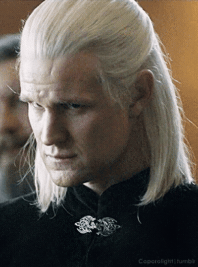 A Man With Long White Hair Has A Black Shirt On GIF