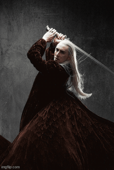 A Man With Long White Hair Is Holding A Large Sword In His Hand . GIF