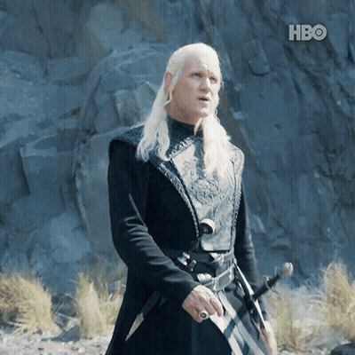 A Man With Long White Hair Is Holding A Sword In Front Of A Hbo Banner GIF