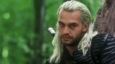 A Man With Long White Hair Is Leaning Against A Tree And Holding A Sword . GIF