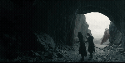 A Man With Long White Hair Is Standing In Front Of A Rock Wall And Looking At The Camera . GIF