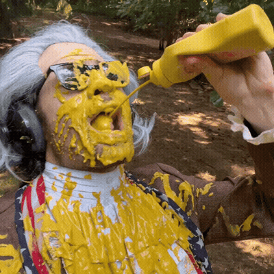 A Man With Mustard On His Face And A Bottle Of Mustard In His Hand GIF