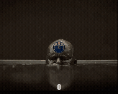 A Man With Oilers On His Head Is In A Bathtub GIF