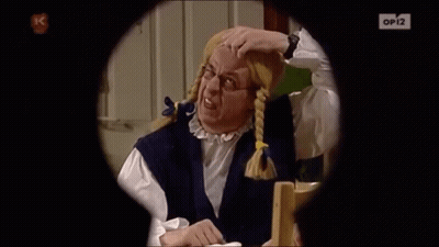A Man With Pigtails And Glasses Is Looking Through A Keyhole With Op12 On The Bottom Right GIF