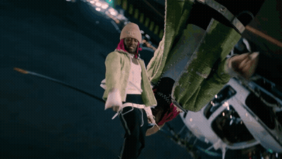 A Man With Pink Hair And A Beanie Stands In Front Of A White Helicopter GIF