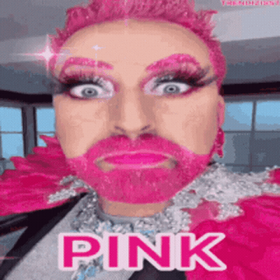 A Man With Pink Hair And A Pink Beard Is Wearing A Pink Costume . GIF