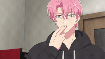 A Man With Pink Hair And Blue Eyes Is Holding His Finger To His Mouth GIF