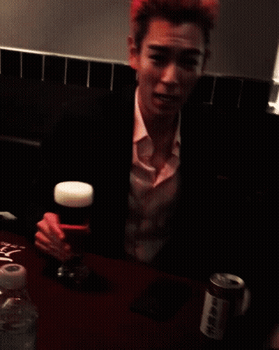 A Man With Pink Hair Holds A Glass Of Beer In His Hand GIF