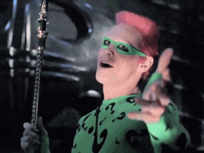 A Man With Pink Hair Is Wearing A Green Sweater With A Question Mark On The Front GIF