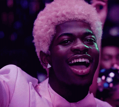 A Man With Pink Hair Is Wearing A Purple Shirt And Bow Tie GIF
