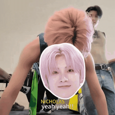 A Man With Pink Hair Says Nicholas Yeah Yeah In Front Of A Picture Of His Face GIF