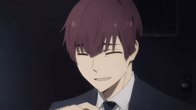A Man With Purple Hair And A Suit Is Smiling With His Eyes Closed GIF