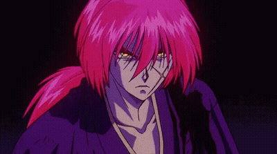 A Man With Purple Hair And Yellow Eyes Is Standing In The Dark . GIF