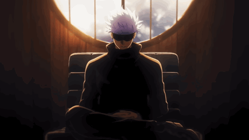 A Man With Purple Hair Is Sitting In Front Of A Large Window GIF