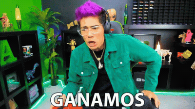 A Man With Purple Hair Is Wearing Headphones And A Green Jacket With The Words Ganamos Written On It GIF