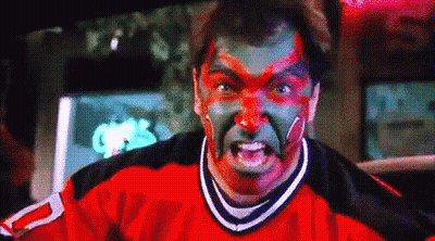 A Man With Red And Green Paint On His Face Is Wearing A Jersey With The Number 2 On It . GIF