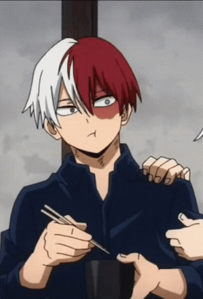 A Man With Red And White Hair Is Holding Chopsticks And Making A Face GIF