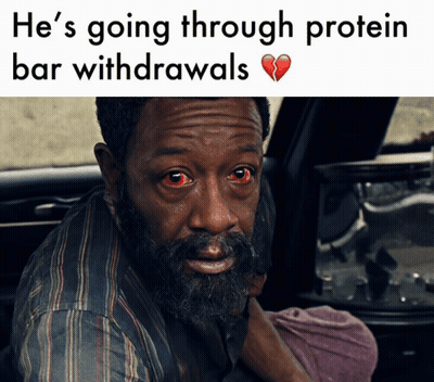 A Man With Red Eyes Is Sitting In The Back Seat Of A Car With A Broken Heart Behind Him GIF