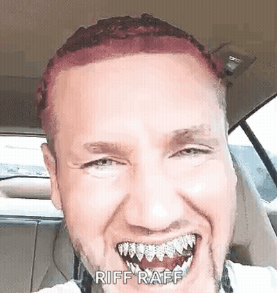 A Man With Red Hair And A Beard Is Sitting In A Car With His Mouth Open . GIF