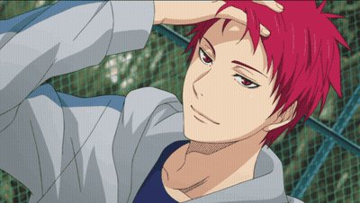 A Man With Red Hair And A Blue Shirt Is Standing In Front Of A Fence GIF