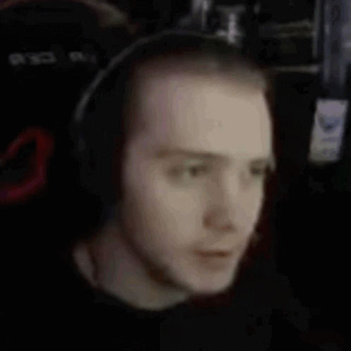 A Man With Red Hair And Headphones On His Neck GIF