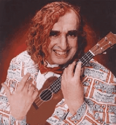 A Man With Red Hair Is Holding A Ukulele And Giving The Middle Finger . GIF