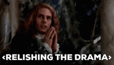 A Man With Red Hair Is Praying In Front Of A Tree With The Words Relish The Drama Written Below Him . GIF