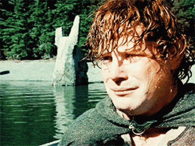 A Man With Red Hair Is Standing In Front Of A Lake GIF