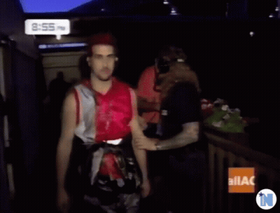 A Man With Red Hair Is Standing In Front Of A Sign That Says Ilac On It GIF