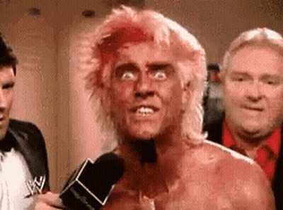 A Man With Red Hair Is Talking Into A Microphone . GIF