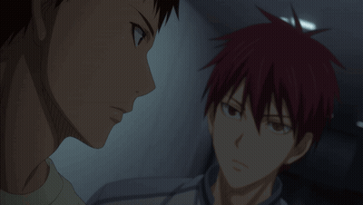 A Man With Red Hair Is Talking To Another Man In A Dark Room GIF