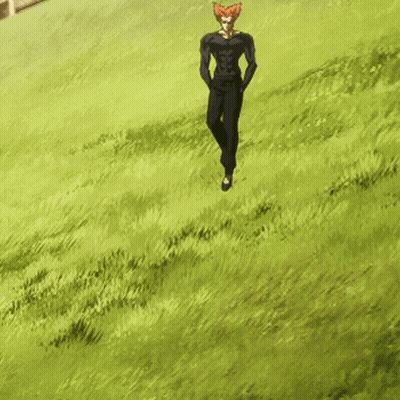 A Man With Red Hair Is Walking In A Field Of Grass GIF