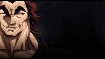 A Man With Red Hair Is Waving His Hand In A Dark Room GIF