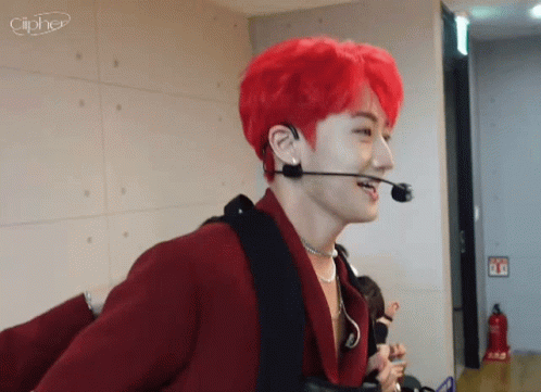 A Man With Red Hair Is Wearing A Microphone And Earphones . GIF