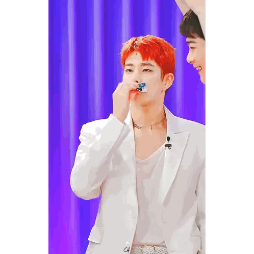 A Man With Red Hair Is Wearing A White Jacket And A White Tank Top Sticker