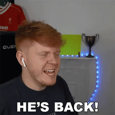 A Man With Red Hair Is Wearing Headphones And Says He 'S Back GIF